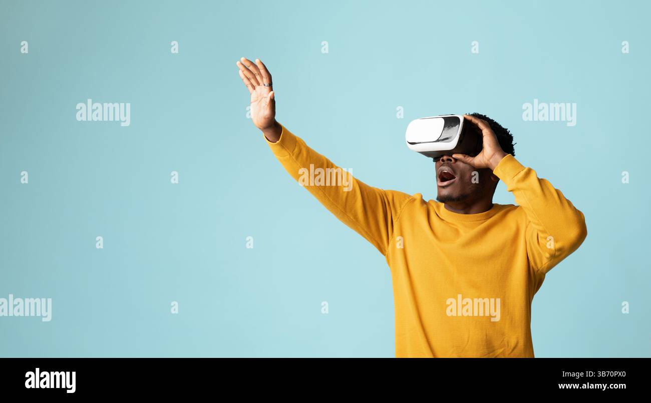 Young african american guy using VR glasses Stock Photo