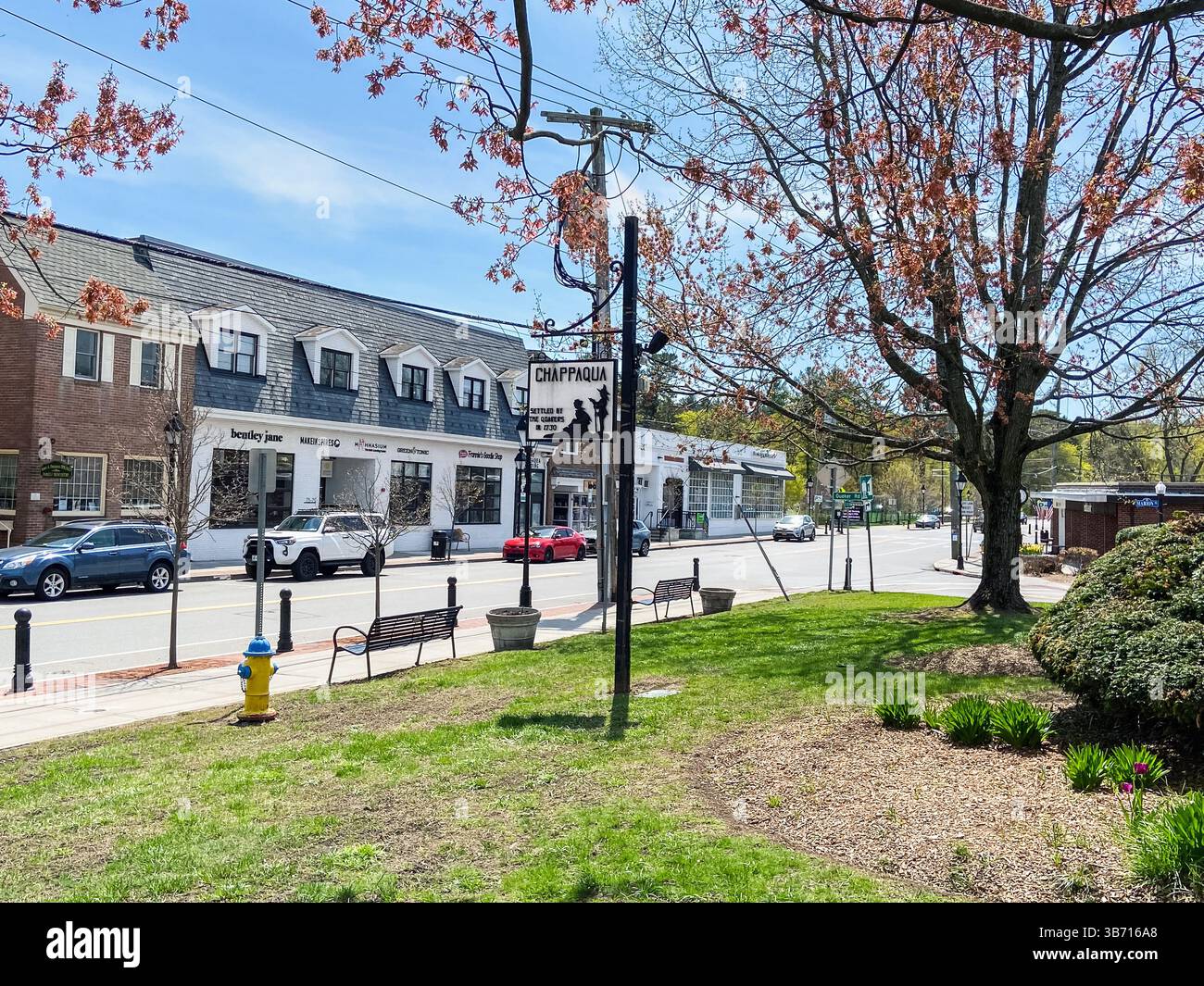 Chappaqua, NY - April 23,  2025: View of downtown shops in the suburban hamlet of  Chappaqua, Westchester County, New York, with commemorative plaque - Smartphone Captured Stock Image