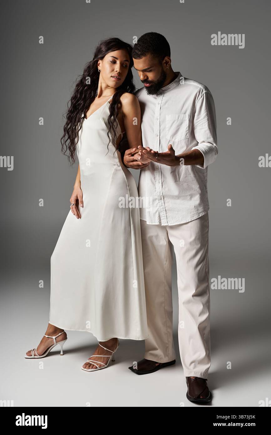 Stand Close A stylish couple stands close, showcasing their love and fashion in a ...
