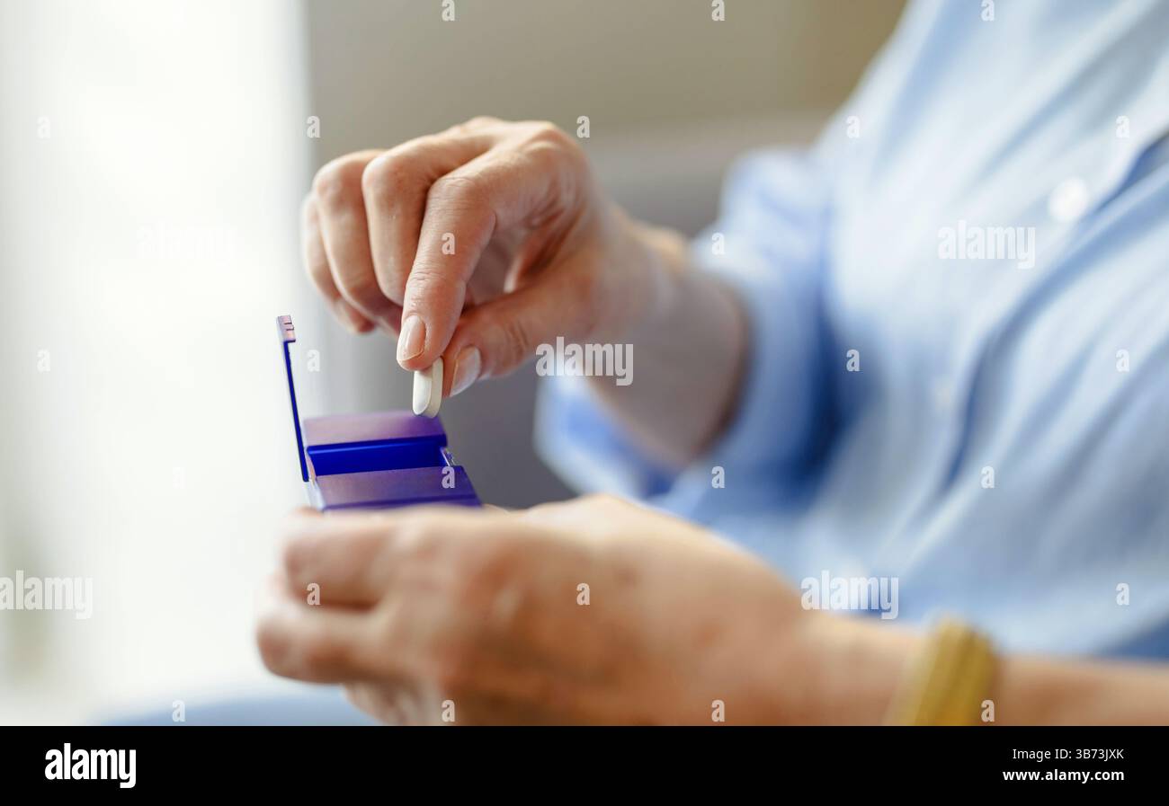 Senior woman taking her medication Stock Photo