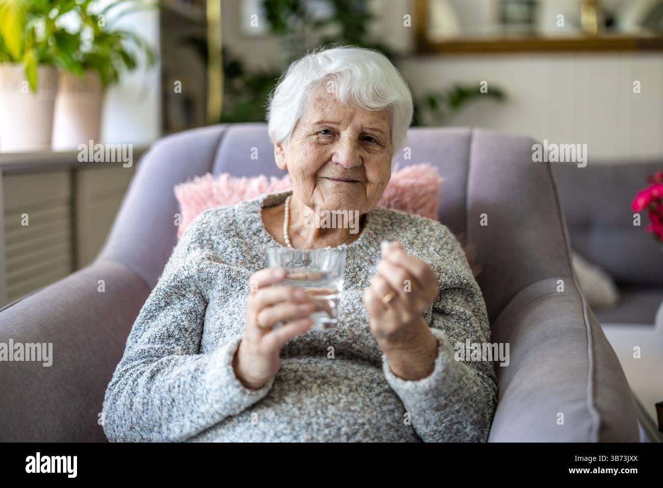 Senior woman taking her medication Stock Photo