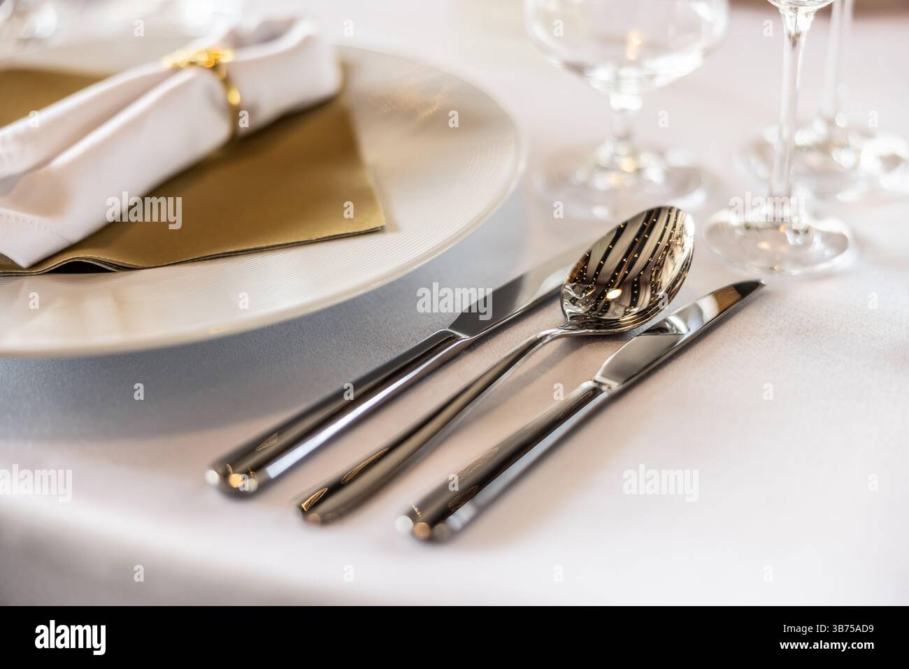 Cutlery Silver-plated cutlery set with intricate designs, elegantly placed on a festive table setting, enhancing the dining experience. Stock Photo