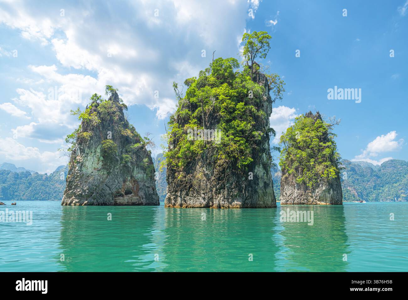 The iconic Three Brothers Rocks rise majestically from the emerald ...