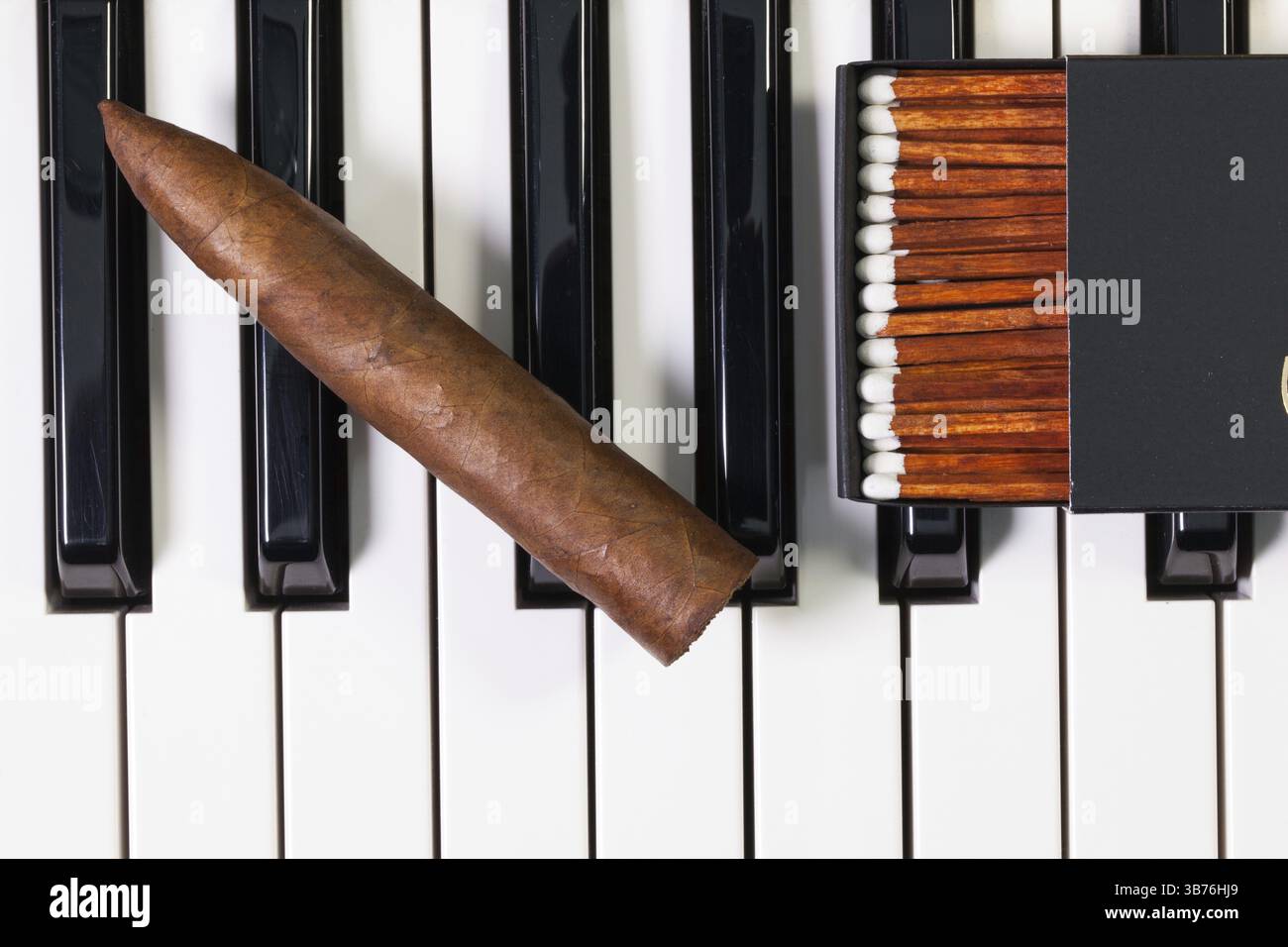 Detail of piano keyboard and luxury cigar Stock Photo - Alamy