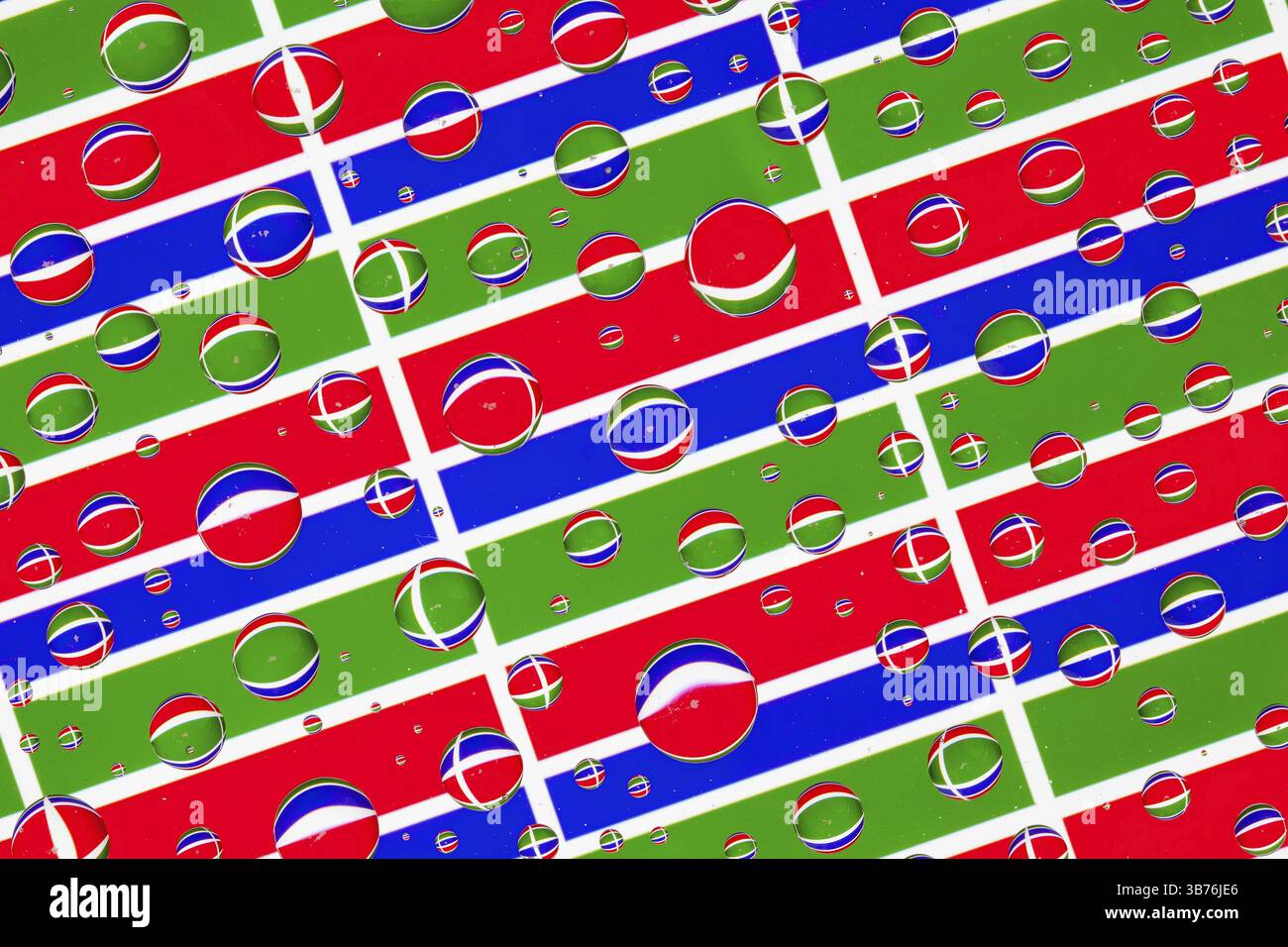 Flags of Gambia behind a glass covered with rain drops.Pattern from ...