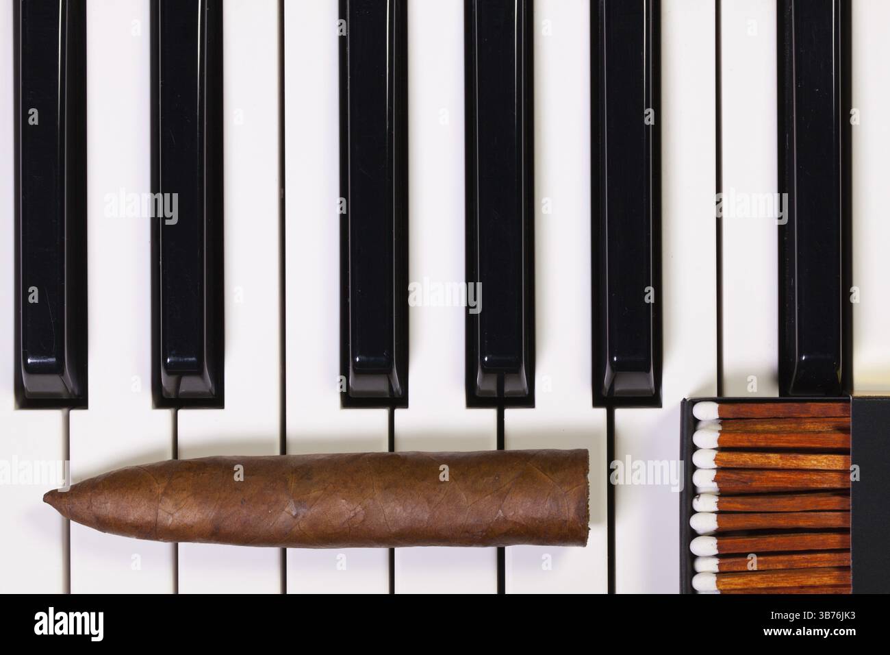 Detail of piano keyboard and luxury cigar Stock Photo - Alamy