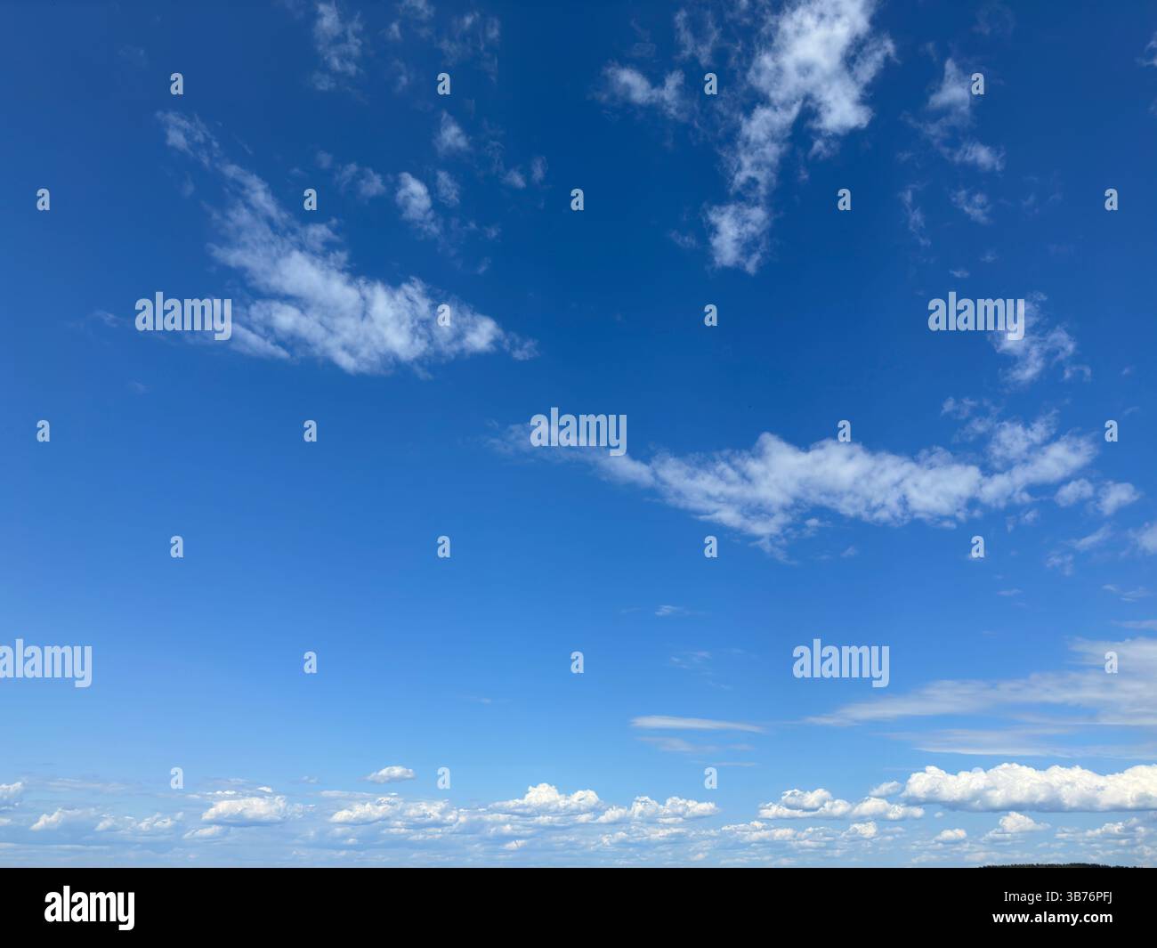 A stunning view of the sky filled with beautiful, fluffy clouds - Smartphone Captured Stock Image