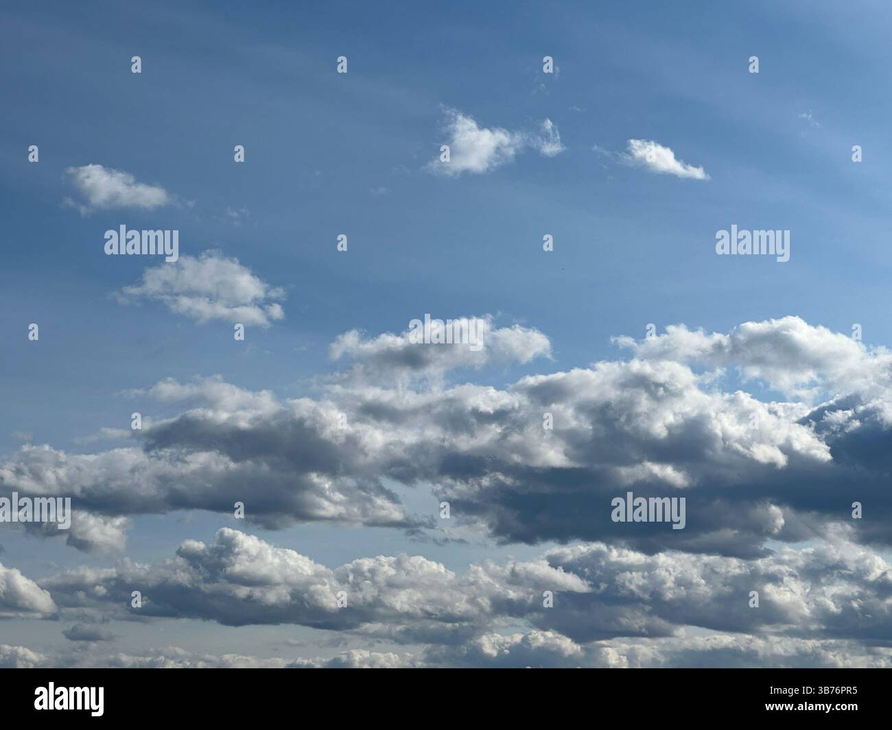 A stunning view of the sky filled with beautiful, fluffy clouds - Smartphone Captured Stock Image