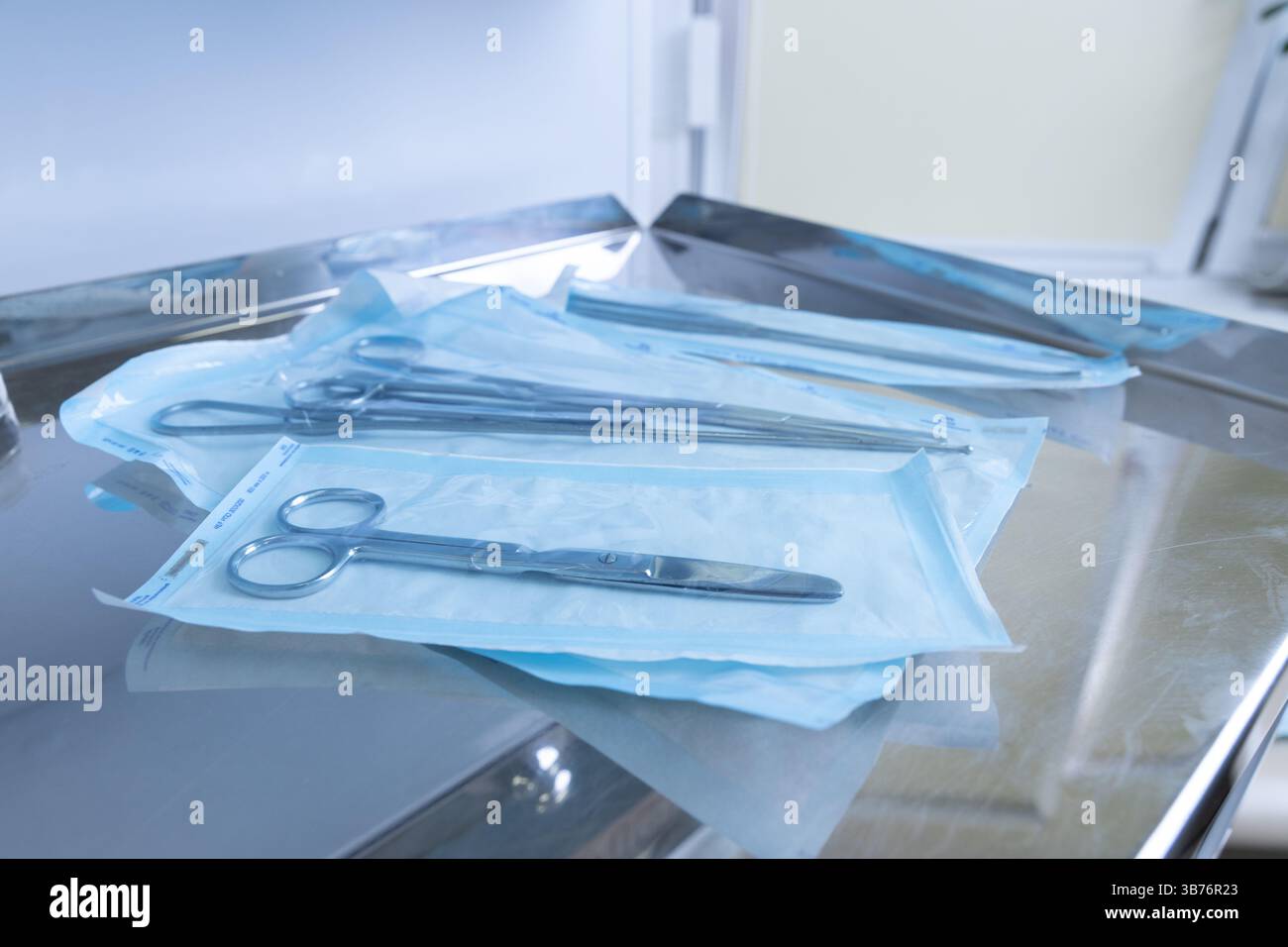 A collection of surgical instruments, notably scissors, is arranged on ...