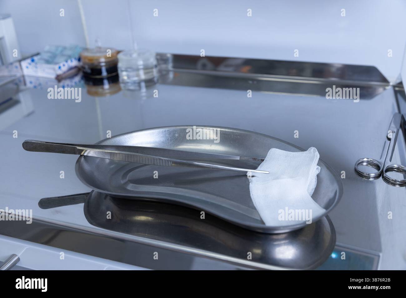 A glimpse of a surgical setup featuring a stainless steel tray holding ...