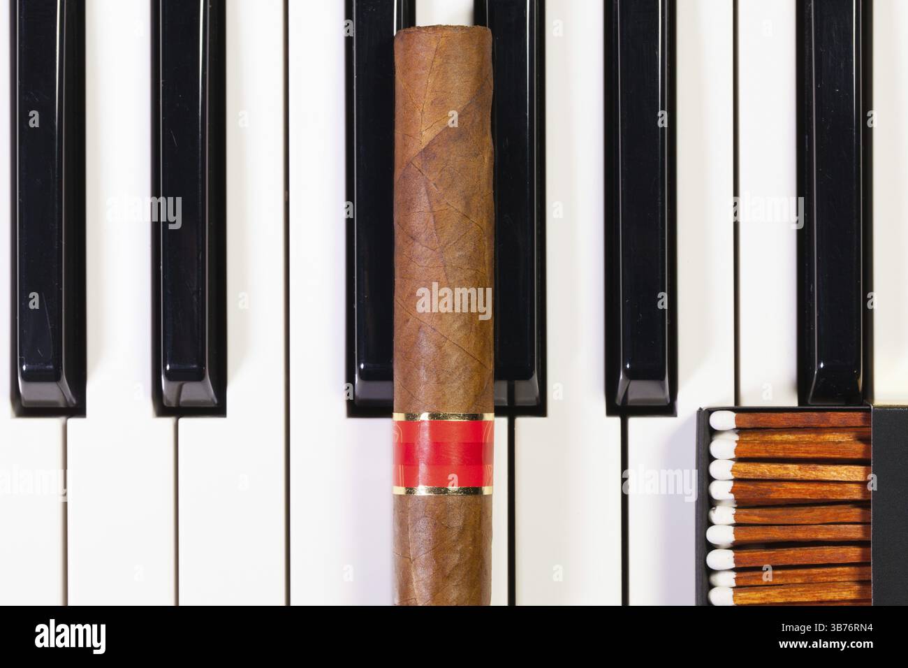 Detail of piano keyboard and luxury cigar Stock Photo - Alamy