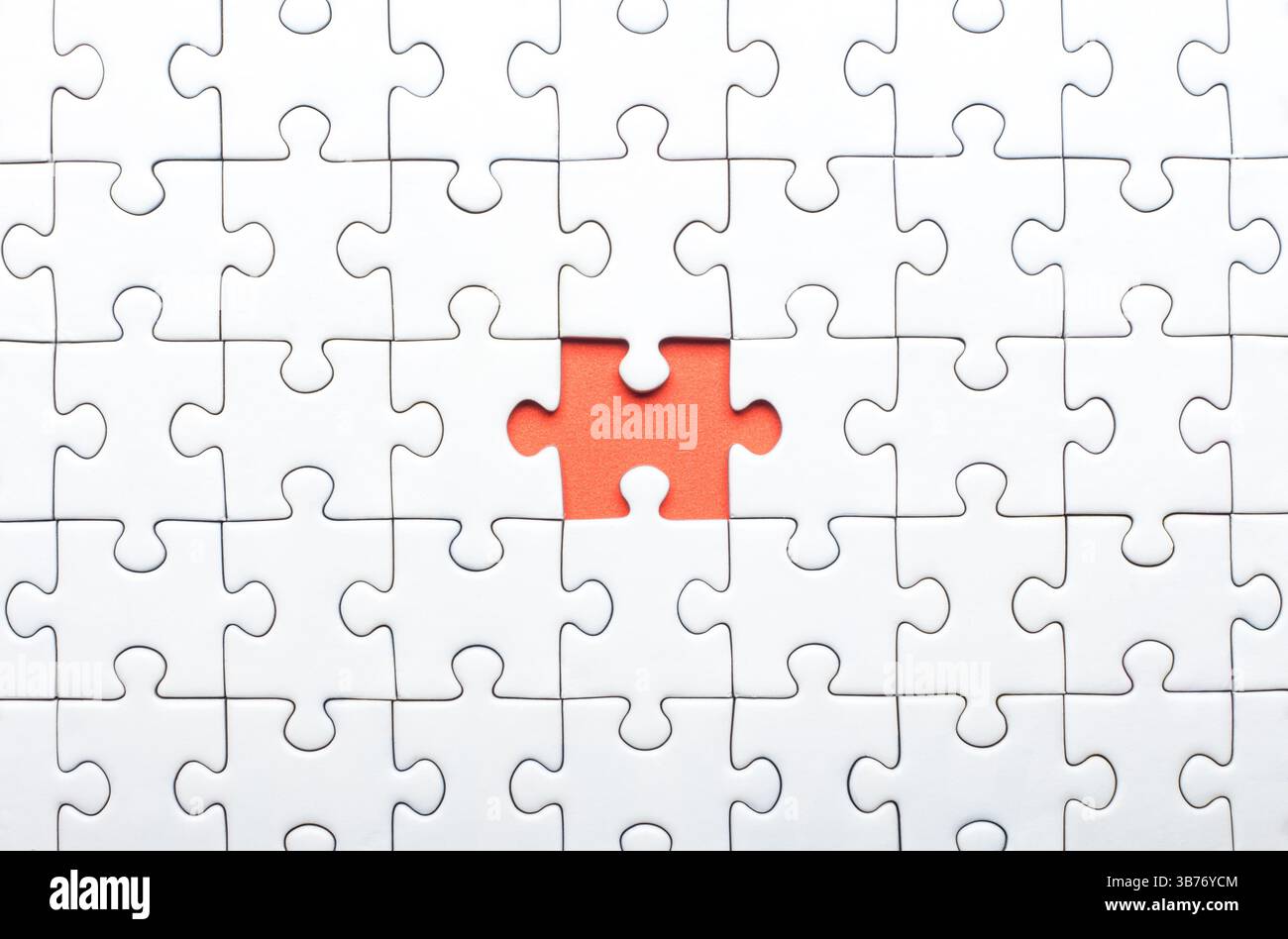 White Puzzle with Single Missing Piece Revealing orange Background Stock Photo