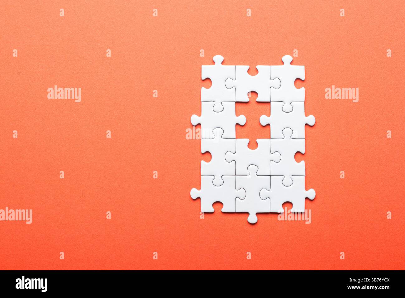 White Puzzle with Missing Piece on Orange Background Stock Photo