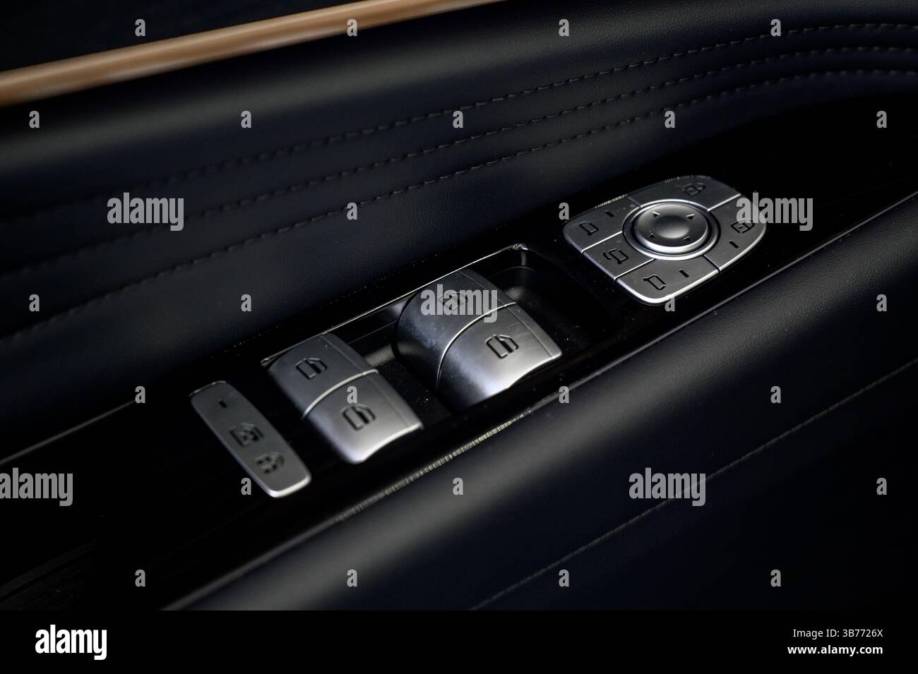 Car door inside close up with door handle and window control and adjustment button Stock Photo
