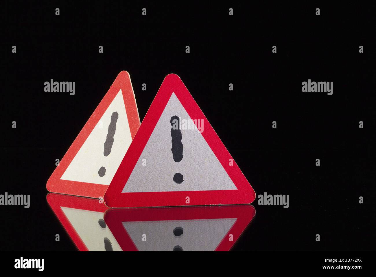 Danger warning signs on the black glass table Stock Photo - Alamy