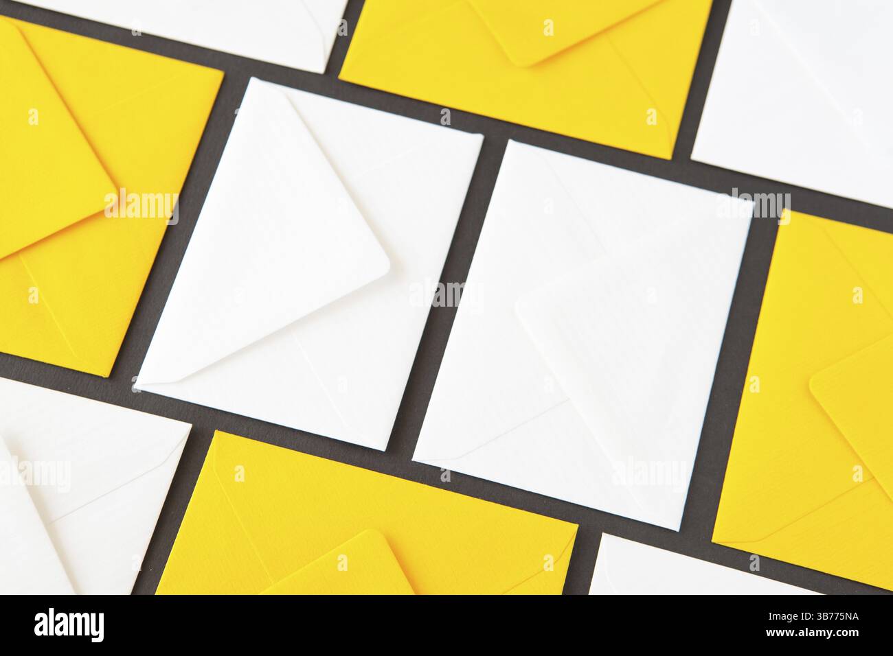 Composition with white and yellow, envelopes on the table. Different colored envelopes on the table Stock Photo