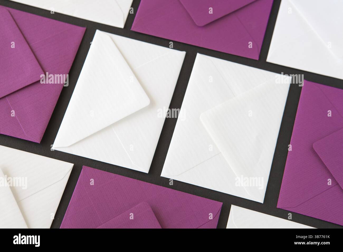 Composition with white and purple envelopes on the table. Different colored envelopes on the table Stock Photo