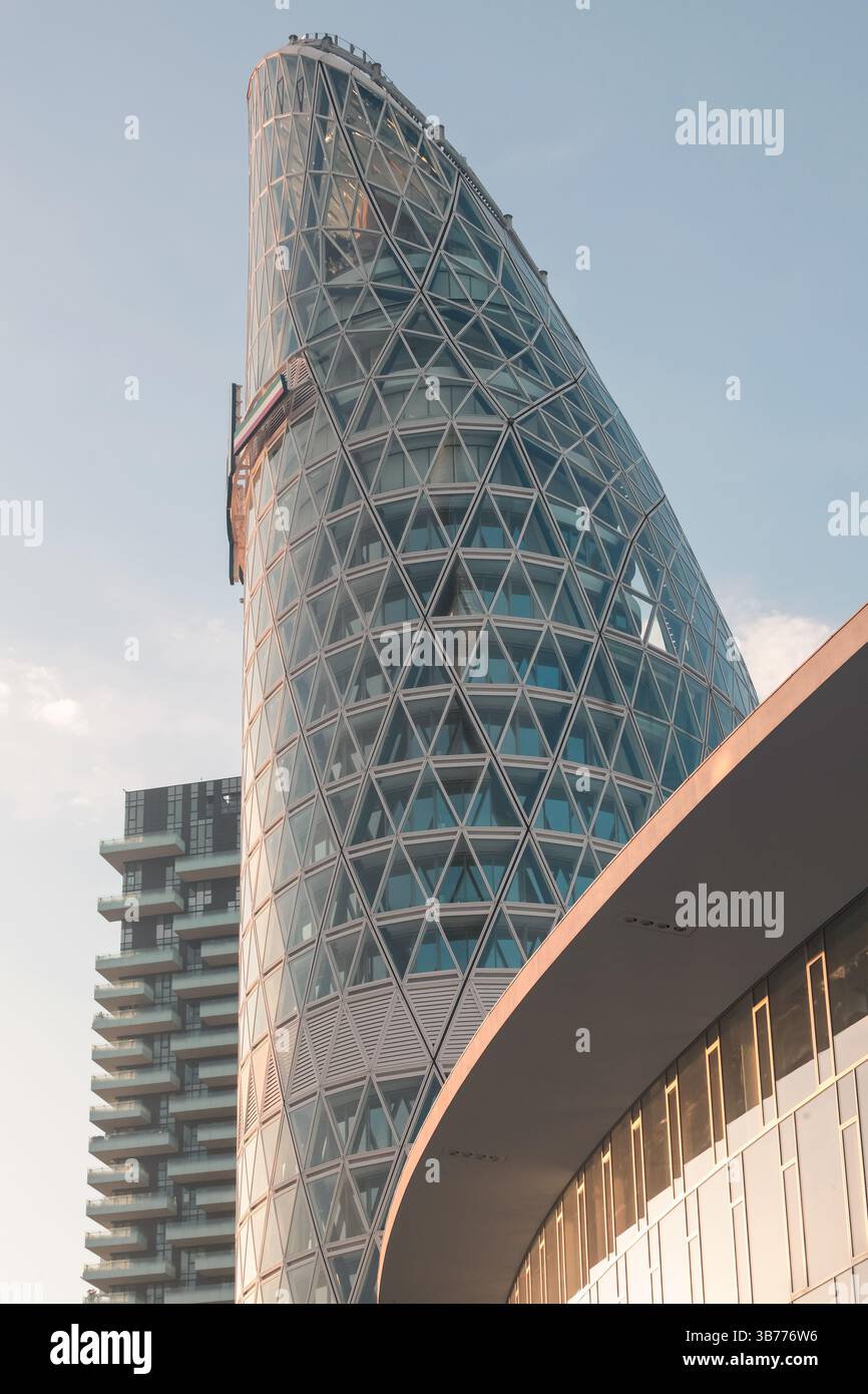 Unipol Building The Unipol Tower in Milan glows at sunrise, showcasing its futuristic ...