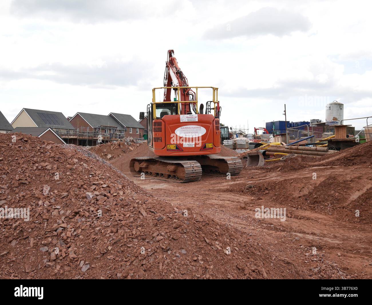 Digger on construction site of new housing development. Devon, UK Stock ...