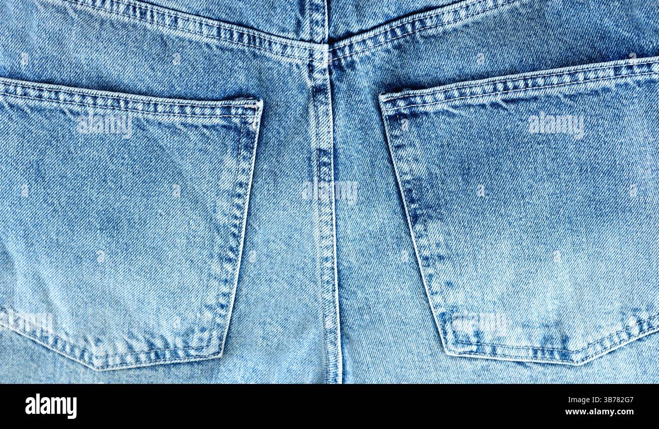 Jeans textile texture background,denim back side pockets backdrop,empty copy space.Blue canvas. Stock Photo