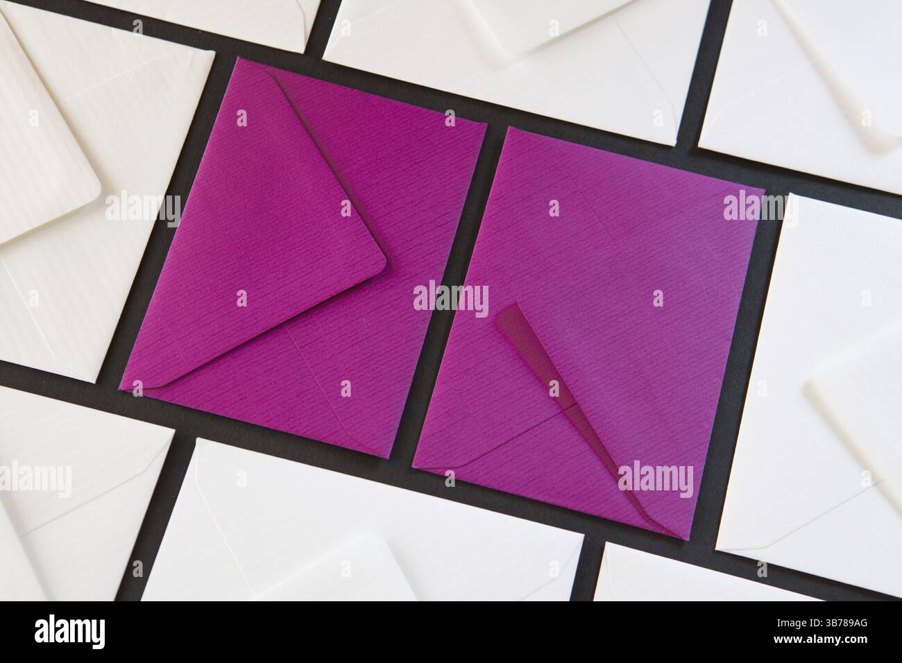 Composition with white and purple envelopes on the table. Different colored envelopes on the table Stock Photo