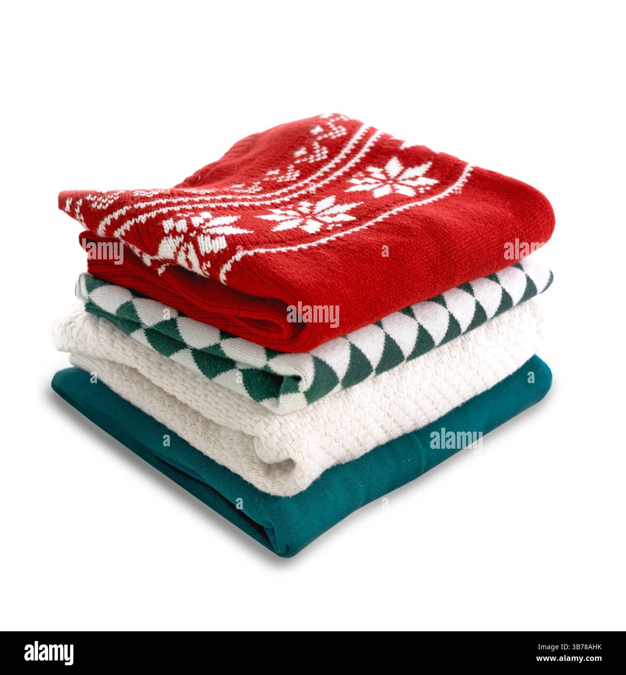 Stack of folded sweaters on white background.Christmas knitted clothes stack. Stock Photo