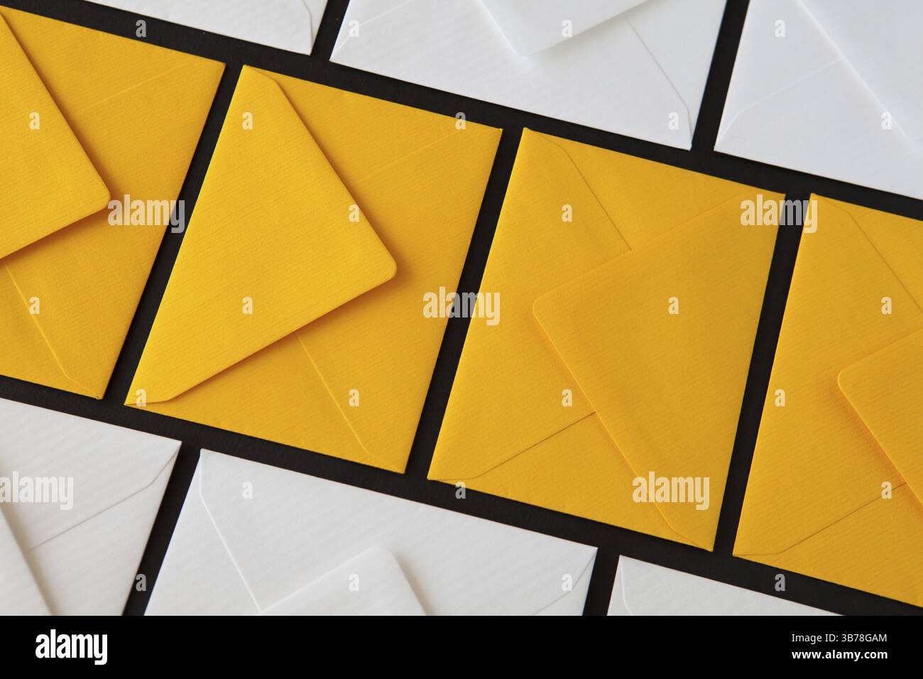 Composition with white and yellow, envelopes on the table. Different colored envelopes on the table Stock Photo