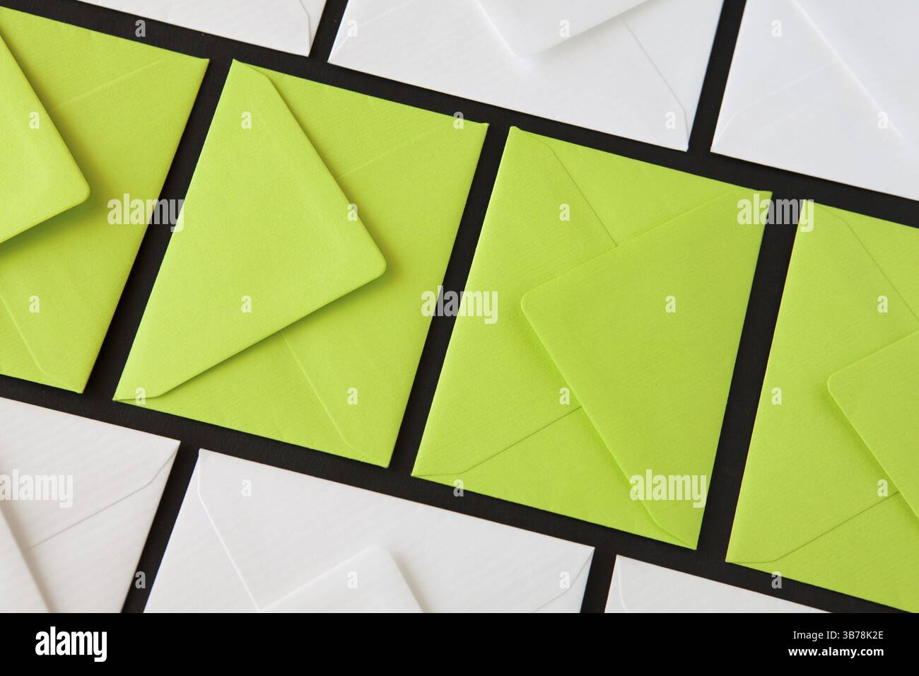 Composition with white and green envelopes on the table. Different colored envelopes on the table Stock Photo