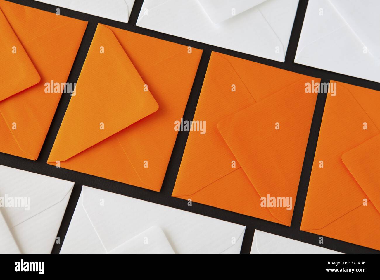 Composition with white and orange envelopes on the table. Different colored envelopes on the table Stock Photo
