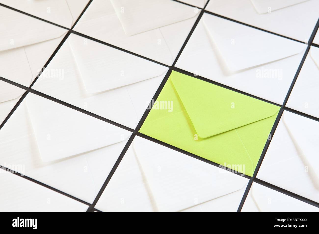 Composition with white and green envelopes on the table. Different colored envelopes on the table Stock Photo