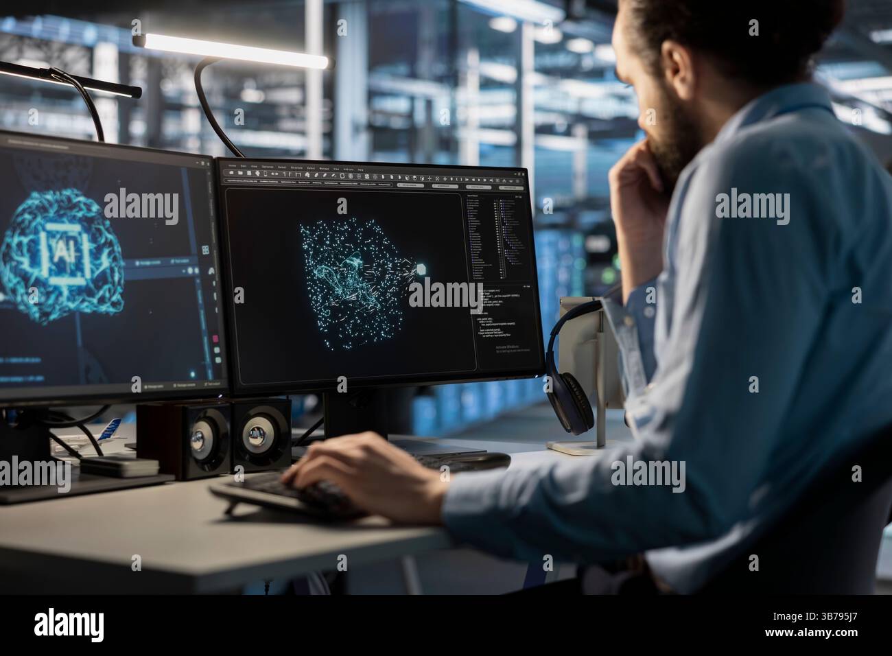 Software developer using computer to oversee server cabinets doing data intensive operations. IT specialist using PC to supervise supercomputers maintaining storage for machine learning Stock Photo