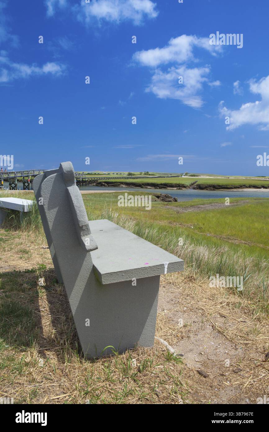 Assachu Concrete bench near the walkway to the dunes. Wooden walkway extends ...