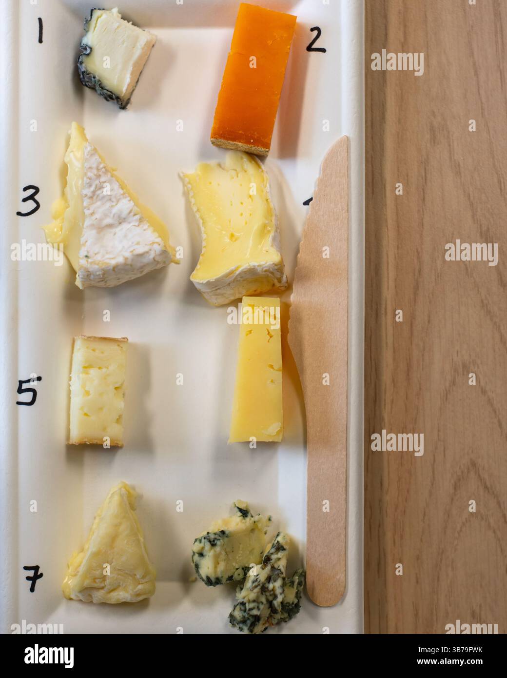 Gourmet selection of seven British artisan cheeses on a rectangular ...