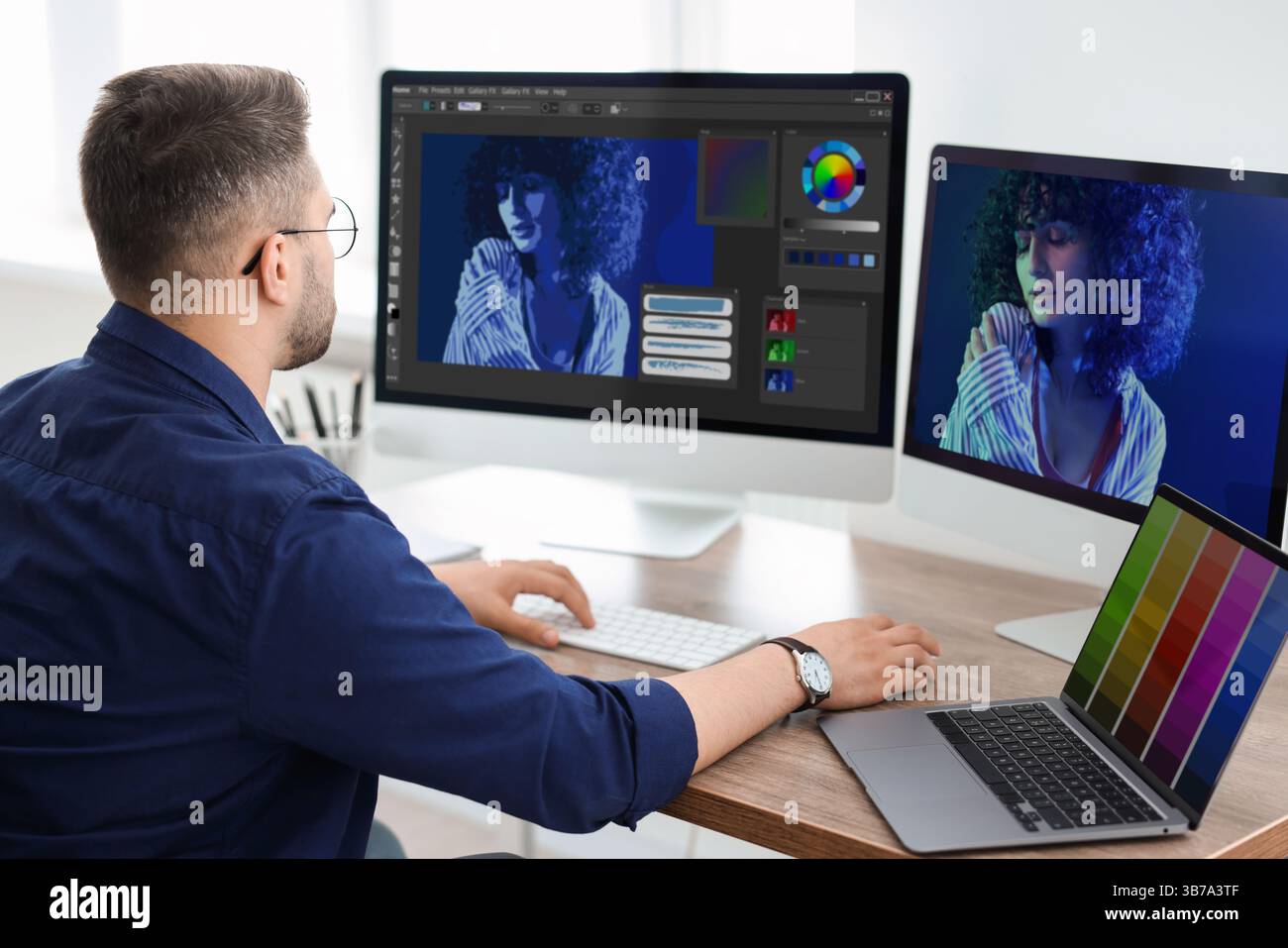Designer working on different computers at table in office Stock Photo