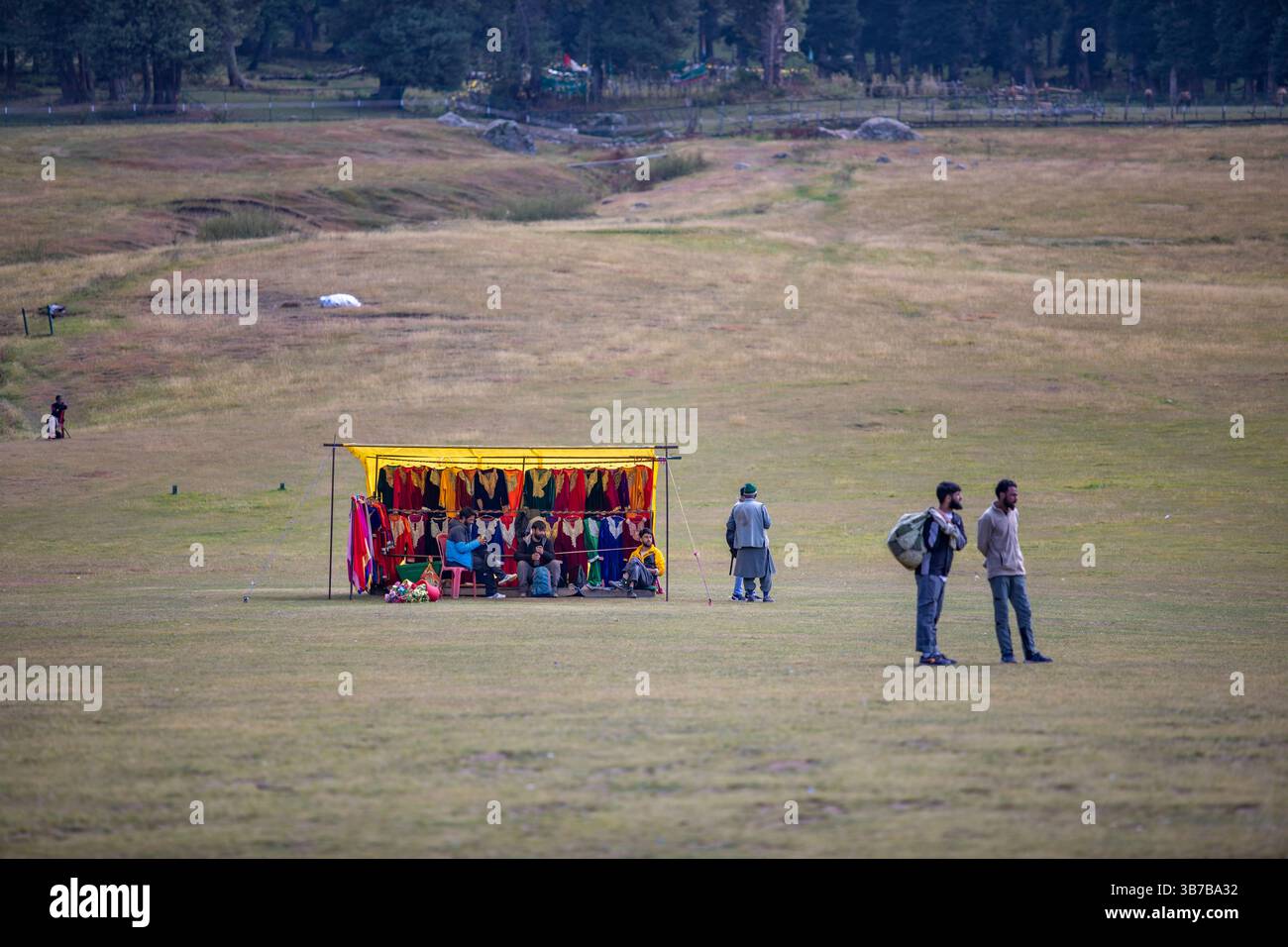 Baisaran Valley in Kashmir, Mini Switzerland of India. Vendors  waiting with traditional Kashmiri outfits; tourists take photos wearing these dresses. Stock Photo