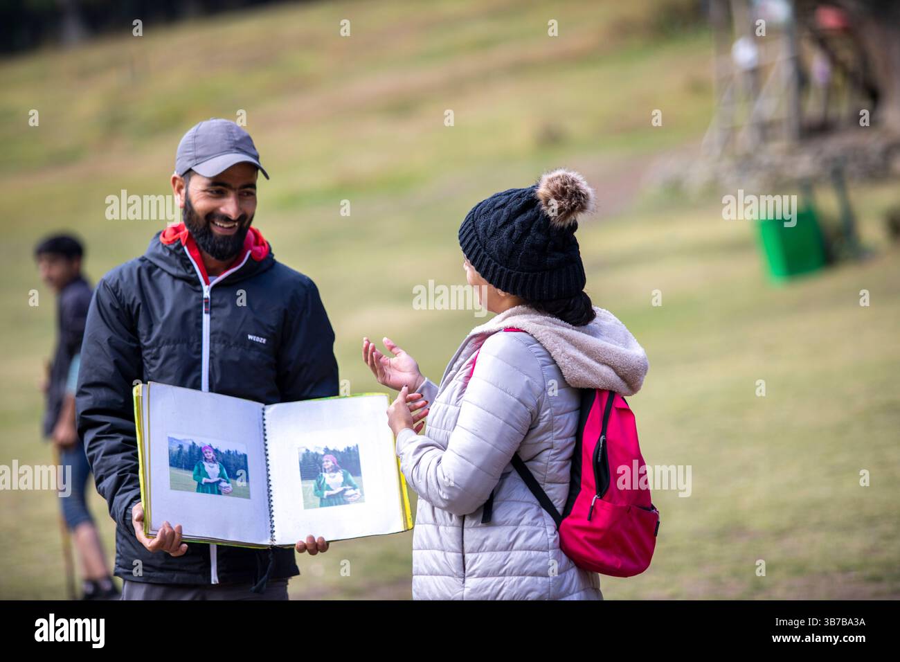 Baisaran Valley in Kashmir, Mini Switzerland of India. Vendor waits with traditional Kashmiri outfits. Stock Photo