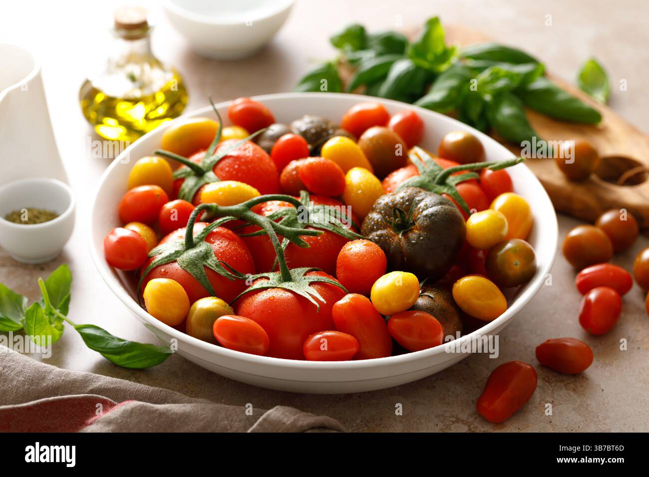 Fresh ripe cherry tomatoes and large red tomatoes Stock Photo