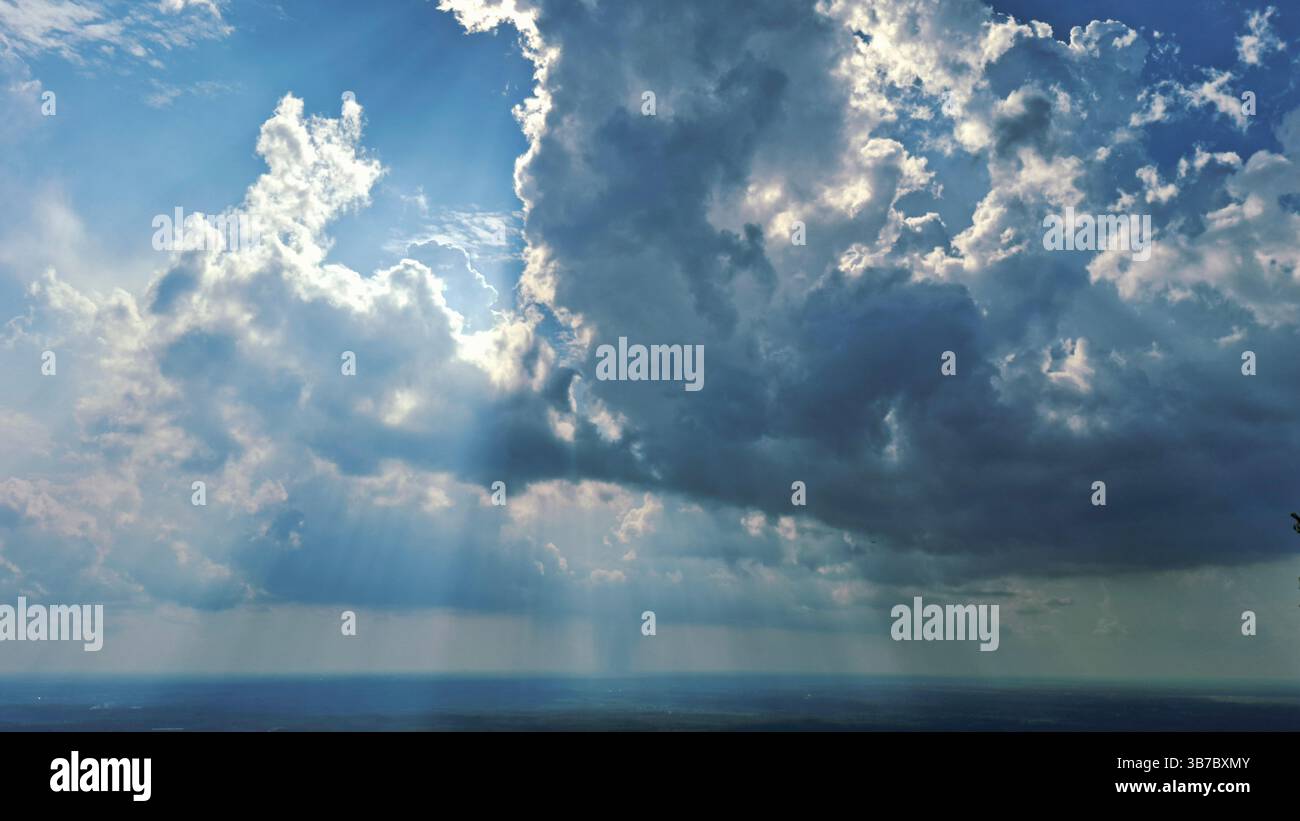 blue sky with bright light between the white clouds Stock Photo