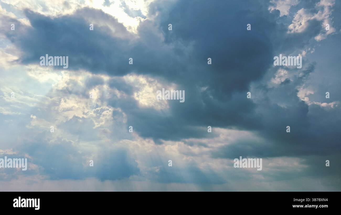 blue sky with bright light between the white clouds Stock Photo