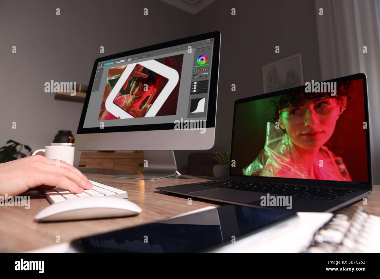 Designer working on different computers at table in office, closeup Stock Photo