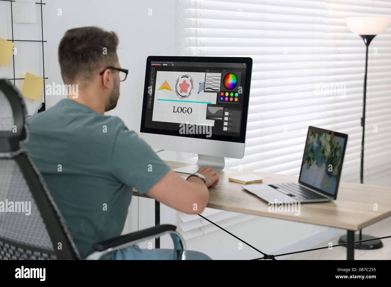 Designer working on different computers at table in office Stock Photo