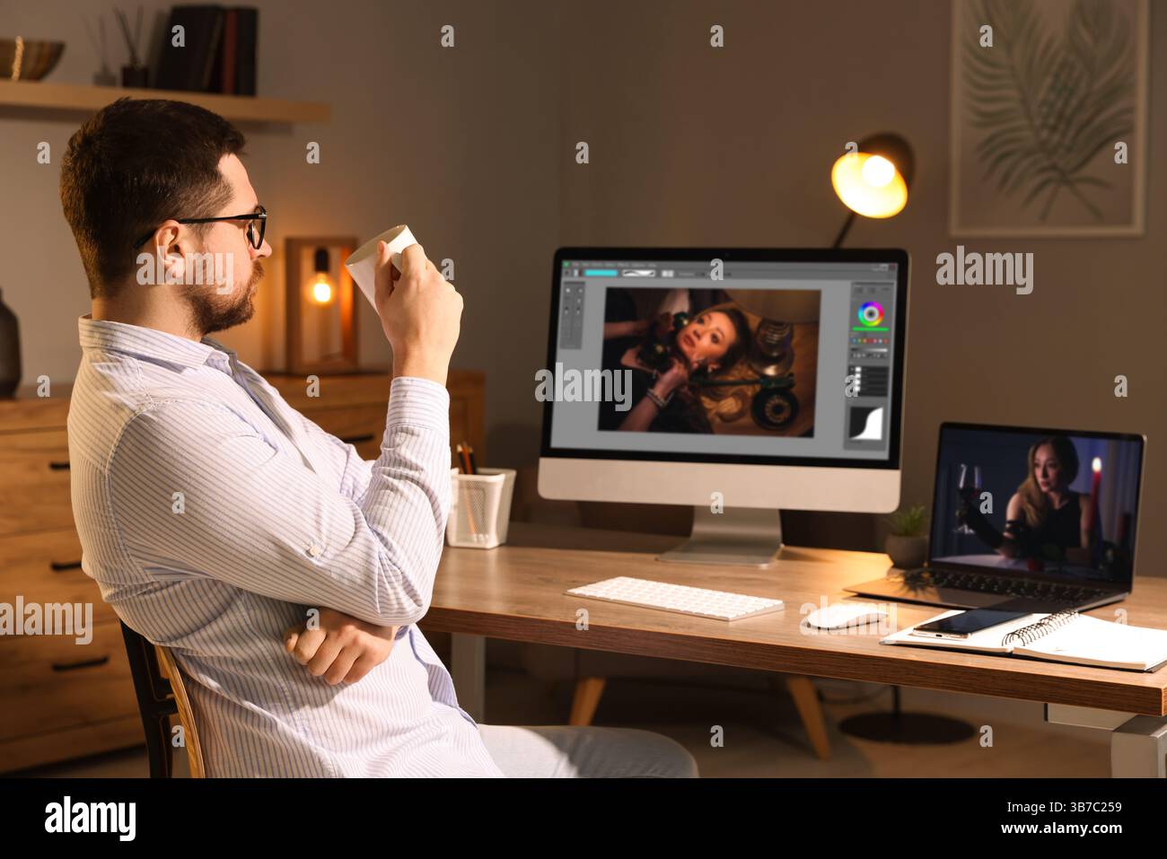 Designer working on different computers at table in office Stock Photo