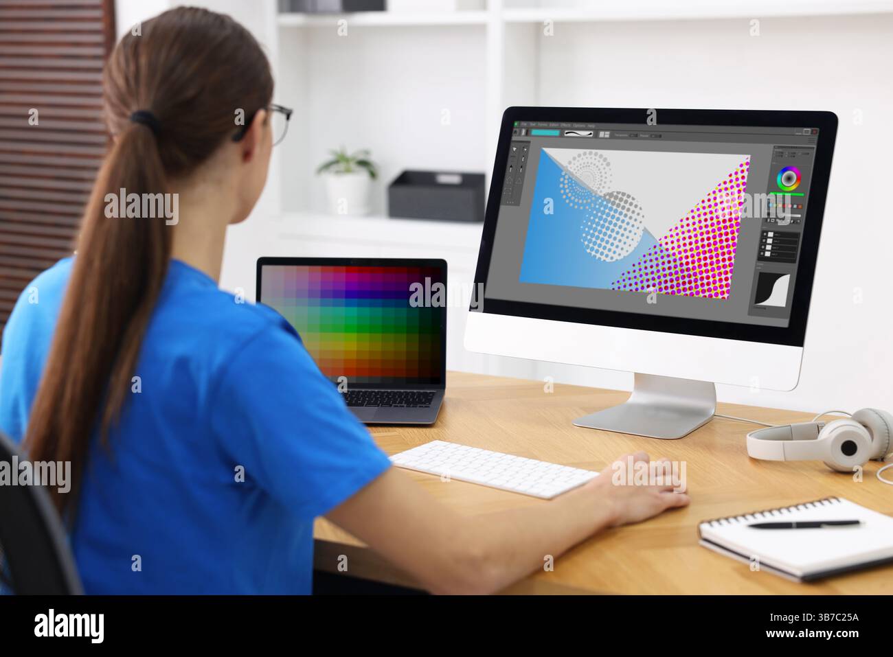 Designer working on different computers at table in office Stock Photo