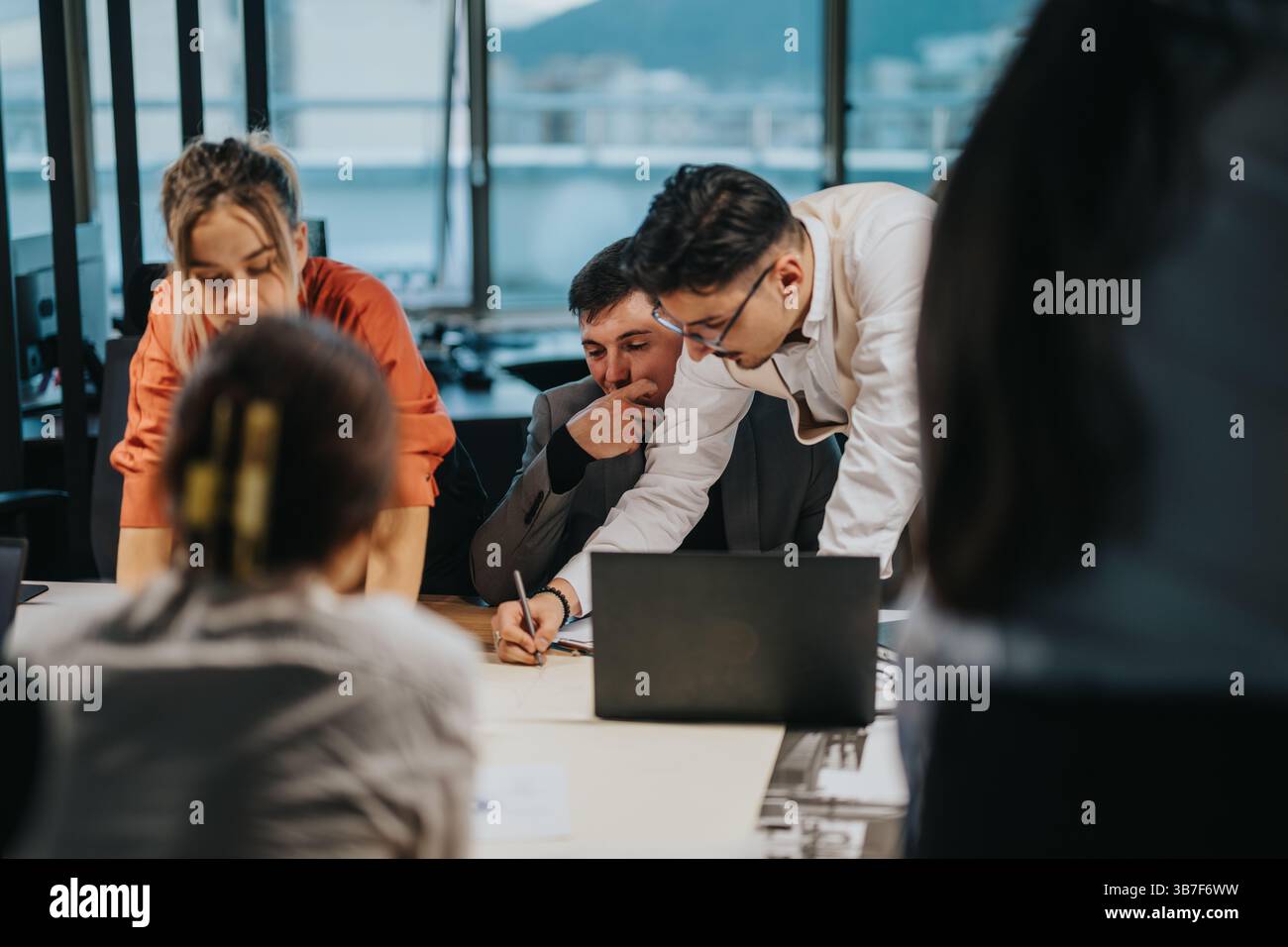 Multicultural team collaborating on project at modern office Stock Photo