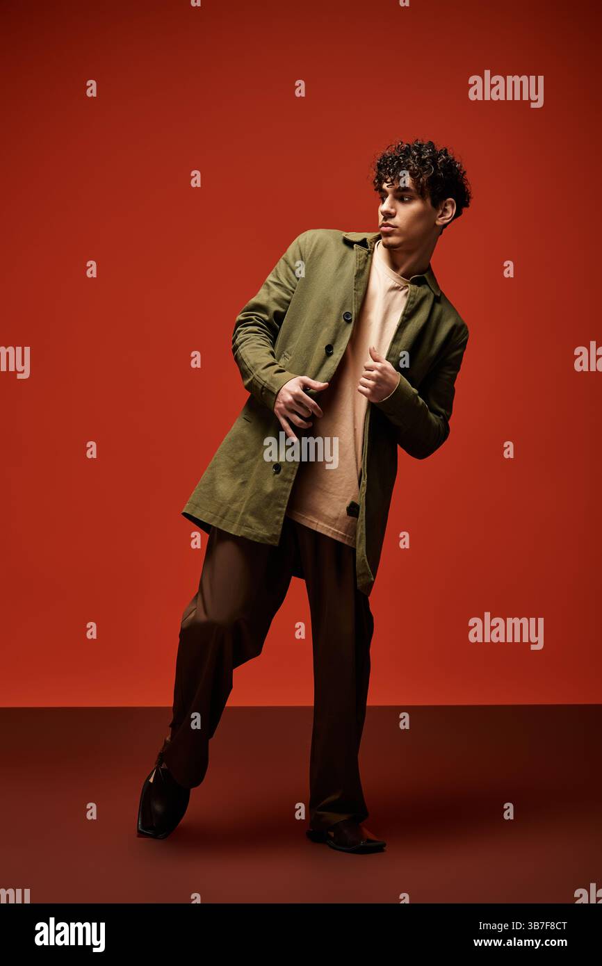 Handsome young man poses confidently, highlighting a chic outfit with ...