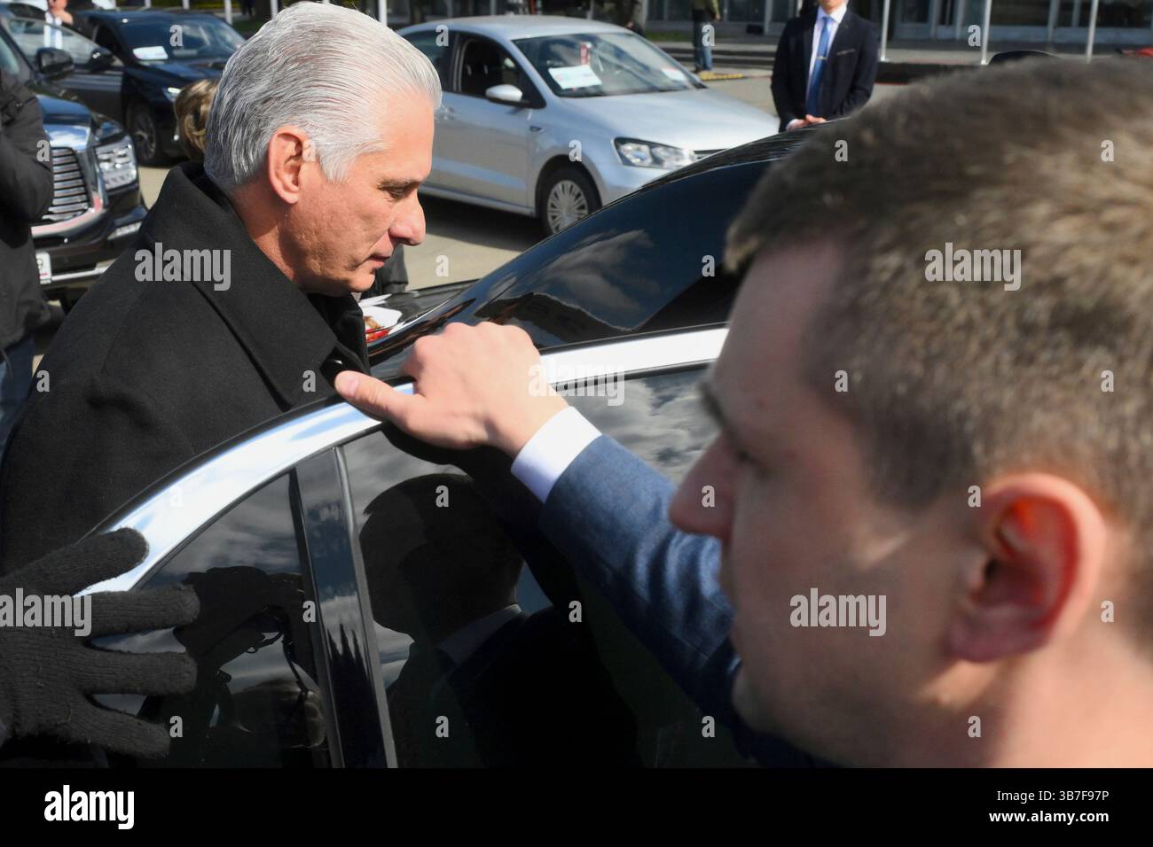 Cuba's President Miguel Diaz-Canel, left, gets in a car upon arrival at ...