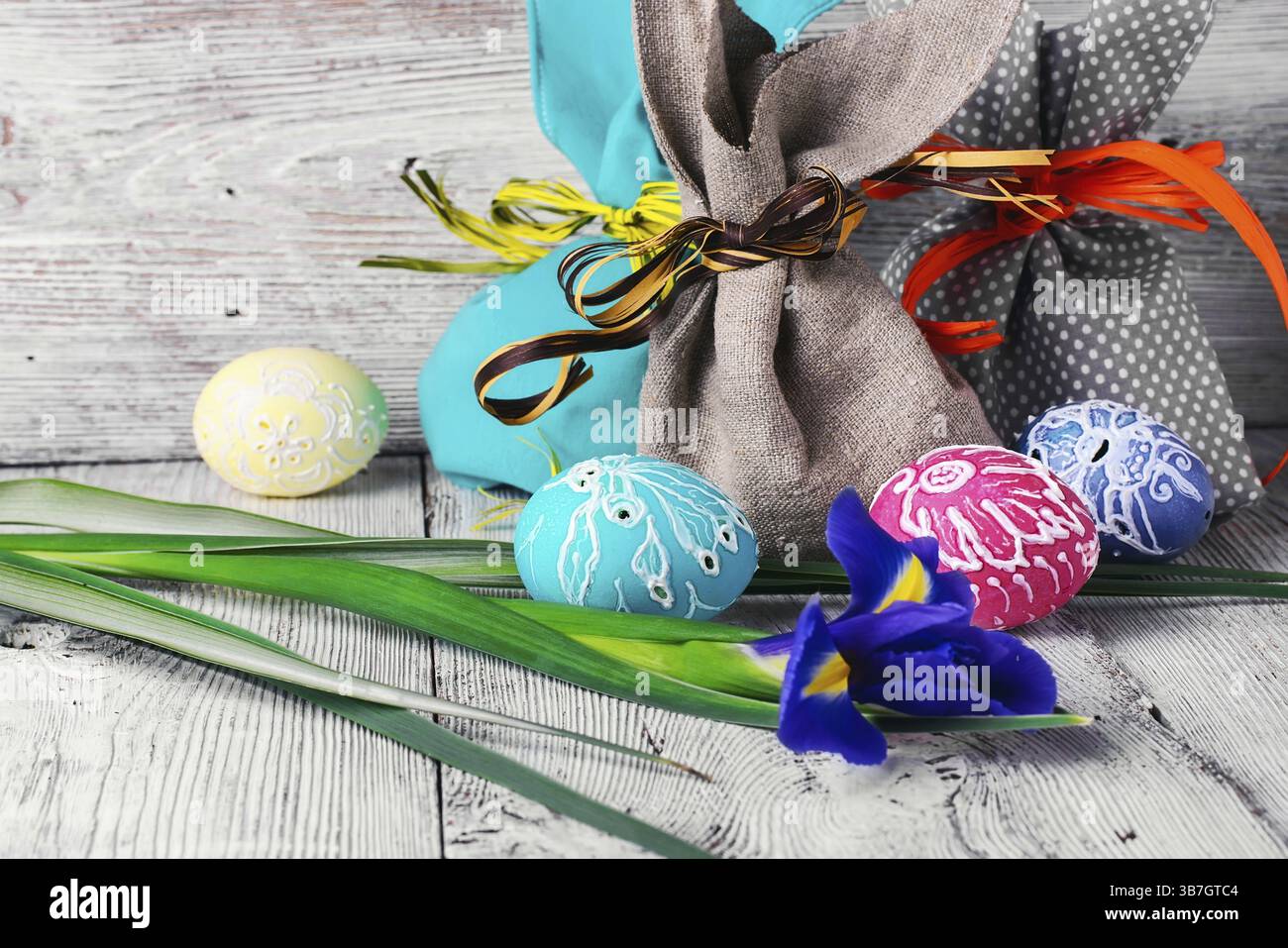 Painted Easter eggs, an iris flower and pouches with ears Stock Photo