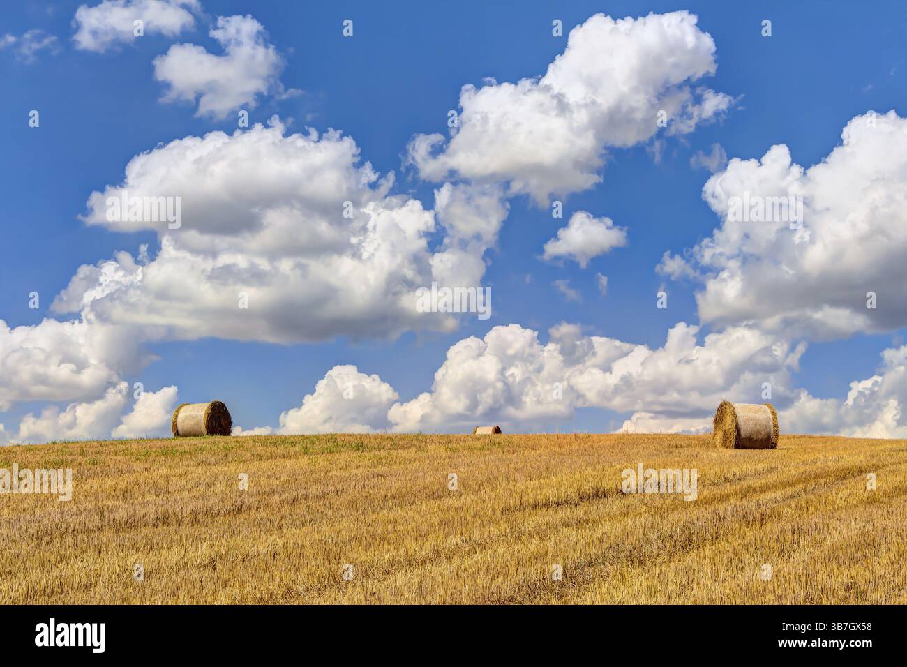 Straw bales at harvest time with blue sky and white clouds Stock Photo ...