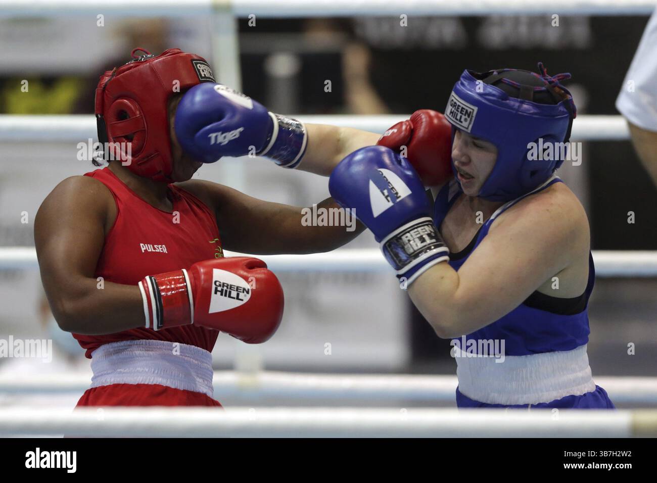 Sofia, Bulgaria - 26 February, 2021: Possantos Perejra (red) of Brazil and Nadezhda Ryabets of Kazakhstan fight in their semifinal round of Middle (W7 Stock Photo