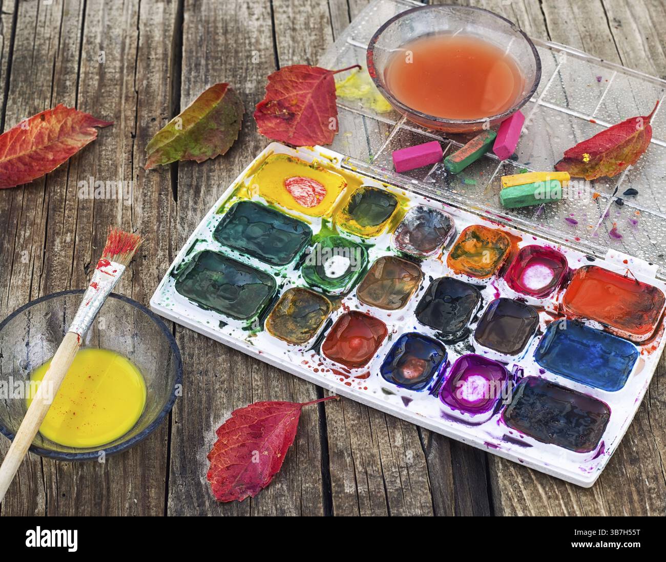 Set of different paint colours and brush for painting on wooden ...